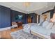 Spacious main bedroom featuring a tray ceiling, wood floors, custom wall treatments, and a television at 6515 Ashbourne Ct, Suwanee, GA 30024
