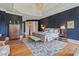Serene main bedroom featuring tray ceilings, hardwood floors, a decorative rug, and elegant furnishings at 6515 Ashbourne Ct, Suwanee, GA 30024