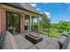Relax on this deck with a fire pit, comfortable seating, and views of the lush backyard at 6515 Ashbourne Ct, Suwanee, GA 30024