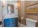 Charming powder room with gold fixtures, custom vanity and decorative wallpaper at 6515 Ashbourne Ct, Suwanee, GA 30024