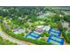 Scenic aerial shot of tennis courts and a pool in a beautiful community surrounded by trees at 6515 Ashbourne Ct, Suwanee, GA 30024