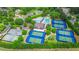 Aerial view of a community featuring well-maintained tennis courts, swimming pool, and verdant landscaping at 6515 Ashbourne Ct, Suwanee, GA 30024