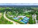 Aerial view of a community featuring well-maintained tennis courts, swimming pool, and verdant landscaping at 6515 Ashbourne Ct, Suwanee, GA 30024