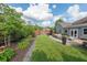 A plush backyard offers an outdoor living space, a manicured lawn, and lush landscaping for relaxing and entertaining at 17 Lexington Ct, Dallas, GA 30157