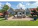 A backyard features a patio living area, manicured lawn, and fresh landscaping at 17 Lexington Ct, Dallas, GA 30157