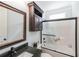 Well-lit bathroom features a shower-tub combination, dark granite countertop, and dark vanity at 17 Lexington Ct, Dallas, GA 30157