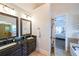 Bathroom featuring dual sinks, granite counters and an open view to the bedroom at 17 Lexington Ct, Dallas, GA 30157