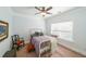 Bright bedroom with a white bed, a comfortable chair, and natural light from the large window at 17 Lexington Ct, Dallas, GA 30157