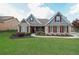 Charming single-Gathering home featuring stone accents, a well-manicured lawn, and a cozy, inviting entrance at 17 Lexington Ct, Dallas, GA 30157