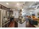 Modern kitchen featuring stainless steel appliances, granite counters, and dark wood cabinets at 17 Lexington Ct, Dallas, GA 30157