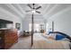This spacious bedroom features a tray ceiling, ceiling fan, and large windows offering great natural light at 17 Lexington Ct, Dallas, GA 30157