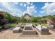 Beautiful outdoor patio with stone pavers, a fire pit, comfortable seating, and lush landscaping at 17 Lexington Ct, Dallas, GA 30157