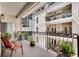 Charming balcony featuring seating, plants, and black iron railings with views of neighboring buildings and greenery at 175 15Th Ne St # 304, Atlanta, GA 30309