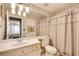 Neutral-toned bathroom with a wide mirror and shower curtain, with an open view to an adjacent bedroom at 175 15Th Ne St # 304, Atlanta, GA 30309