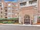 Elegant brick building entrance featuring a beautifully arched entry, lion statues, and manicured landscaping at 175 15Th Ne St # 304, Atlanta, GA 30309