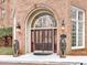 Beautiful brick building entrance with double doors, arched entryway, and lion statues at 175 15Th Ne St # 304, Atlanta, GA 30309