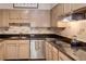 Close-up of a kitchen with stainless steel sink, cooktop, and light wood cabinetry at 175 15Th Ne St # 304, Atlanta, GA 30309