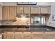 Kitchen with granite countertops, cooktop, light wood cabinets, and pass-through to the living area at 175 15Th Ne St # 304, Atlanta, GA 30309