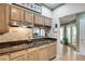 Open kitchen with granite countertops, light wood cabinets, and view into adjacent living areas at 175 15Th Ne St # 304, Atlanta, GA 30309
