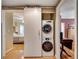 Convenient laundry room with stacked washer and dryer units and built-in storage for optimal organization at 175 15Th Ne St # 304, Atlanta, GA 30309