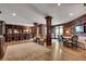 Elegant living room featuring wood paneling, columns, a full bar, and a cozy seating area at 175 15Th Ne St # 304, Atlanta, GA 30309