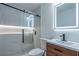 Modern bathroom with a glass-enclosed shower, wood cabinet, and illuminated mirror at 2859 Spring Villa Se Ln, Smyrna, GA 30080