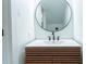 Modern bathroom features updated vanity with round mirror and contemporary faucet at 2859 Spring Villa Se Ln, Smyrna, GA 30080