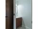 Stylish half-bathroom with a modern vanity and a sleek, round mirror at 2859 Spring Villa Se Ln, Smyrna, GA 30080