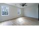Bright bedroom with hardwood floors, two windows, and a ceiling fan at 2859 Spring Villa Se Ln, Smyrna, GA 30080