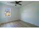 Bedroom with new hardwood floors, window, and ceiling fan at 2859 Spring Villa Se Ln, Smyrna, GA 30080