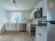 A modern kitchen with white cabinets, stainless steel appliances, and wood-look flooring at 2859 Spring Villa Se Ln, Smyrna, GA 30080