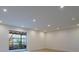 A bright living room with recessed lighting, sliding glass doors, and light wood-look flooring at 2859 Spring Villa Se Ln, Smyrna, GA 30080