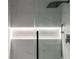 Close up of a tile shower with a rainfall shower head and glass doors at 2859 Spring Villa Se Ln, Smyrna, GA 30080