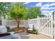 Outdoor patio space with white picket fence and lovely shrubbery at 8730 Parker Pl, Roswell, GA 30076
