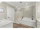 Spacious bathroom featuring separate shower and soaking tub, double vanity, and tile flooring at 8730 Parker Pl, Roswell, GA 30076