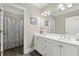 Bright bathroom boasts a double vanity, modern fixtures, and shower/tub combo at 8730 Parker Pl, Roswell, GA 30076