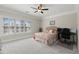 Spacious bedroom featuring a ceiling fan, large windows, and a comfortable bed with an office setup at 8730 Parker Pl, Roswell, GA 30076