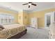 Sunny bedroom featuring carpet flooring, a ceiling fan, and access to a bathroom with a shower at 8730 Parker Pl, Roswell, GA 30076
