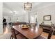 Open dining room with wood table, modern light fixture, and open access to the living room at 8730 Parker Pl, Roswell, GA 30076