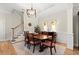 Traditional dining room with decorative rug, wood table, and staircase to the left at 8730 Parker Pl, Roswell, GA 30076