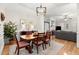 Open dining room with hardwood floors, decorative lighting, and access to the living room at 8730 Parker Pl, Roswell, GA 30076