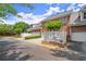 Charming brick townhome featuring a white picket fence and attached garage, perfect for comfortable living at 8730 Parker Pl, Roswell, GA 30076