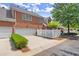 Exterior facade of townhome featuring driveway and partial picket fence at 8730 Parker Pl, Roswell, GA 30076