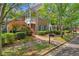 Beautiful brick townhome with manicured landscaping, walkway and a charming porch, offering curb appeal at 8730 Parker Pl, Roswell, GA 30076