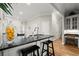 Modern kitchen featuring a black granite countertop bar and ample lighting at 8730 Parker Pl, Roswell, GA 30076