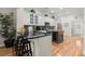 Charming kitchen features white cabinets, black countertops, stainless steel appliances and wooden floors at 8730 Parker Pl, Roswell, GA 30076