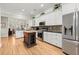 Spacious kitchen with stainless steel appliances, white cabinets and dark island with wood top at 8730 Parker Pl, Roswell, GA 30076