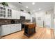 Bright kitchen with white cabinets, stainless steel appliances and a wood-top kitchen island at 8730 Parker Pl, Roswell, GA 30076