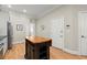 Kitchen includes stainless steel appliances, island with wood top, and access to garage at 8730 Parker Pl, Roswell, GA 30076