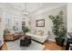 Comfortable living area with hardwood floors, neutral tones, and a view of the neighborhood through bright windows at 8730 Parker Pl, Roswell, GA 30076